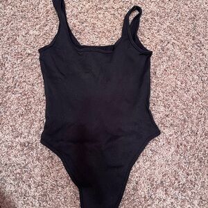 Black body hugging bodysuit